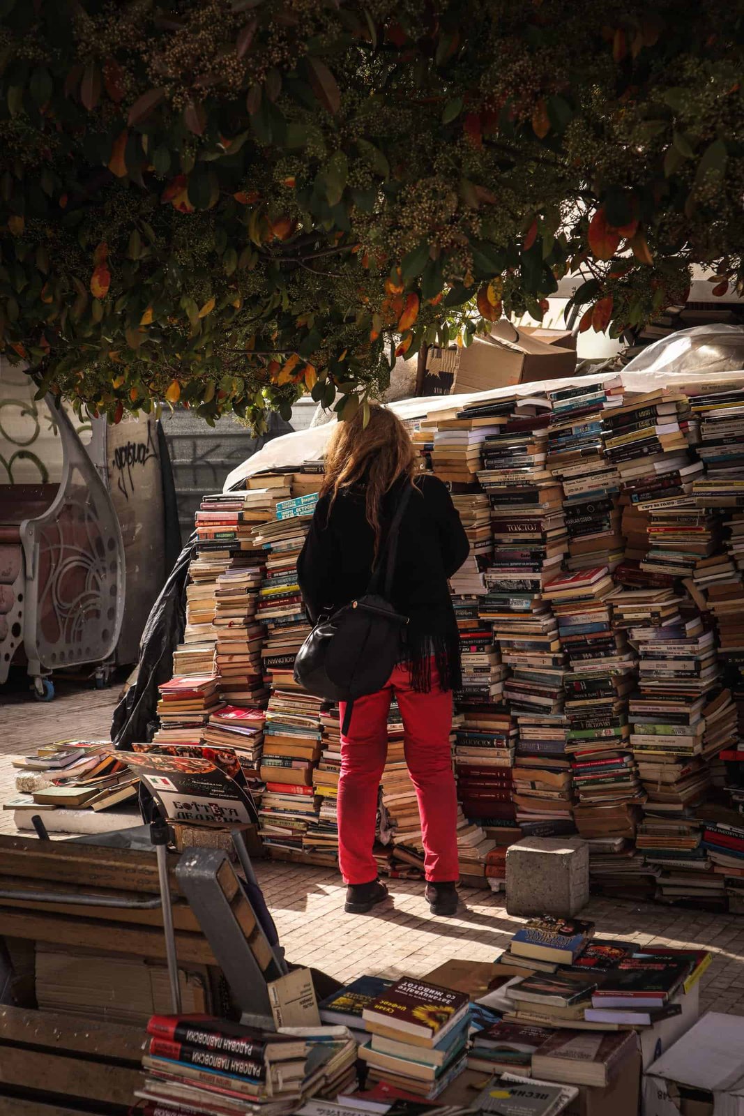 Free A Person Looking At A Pile Of Books Stock Photo