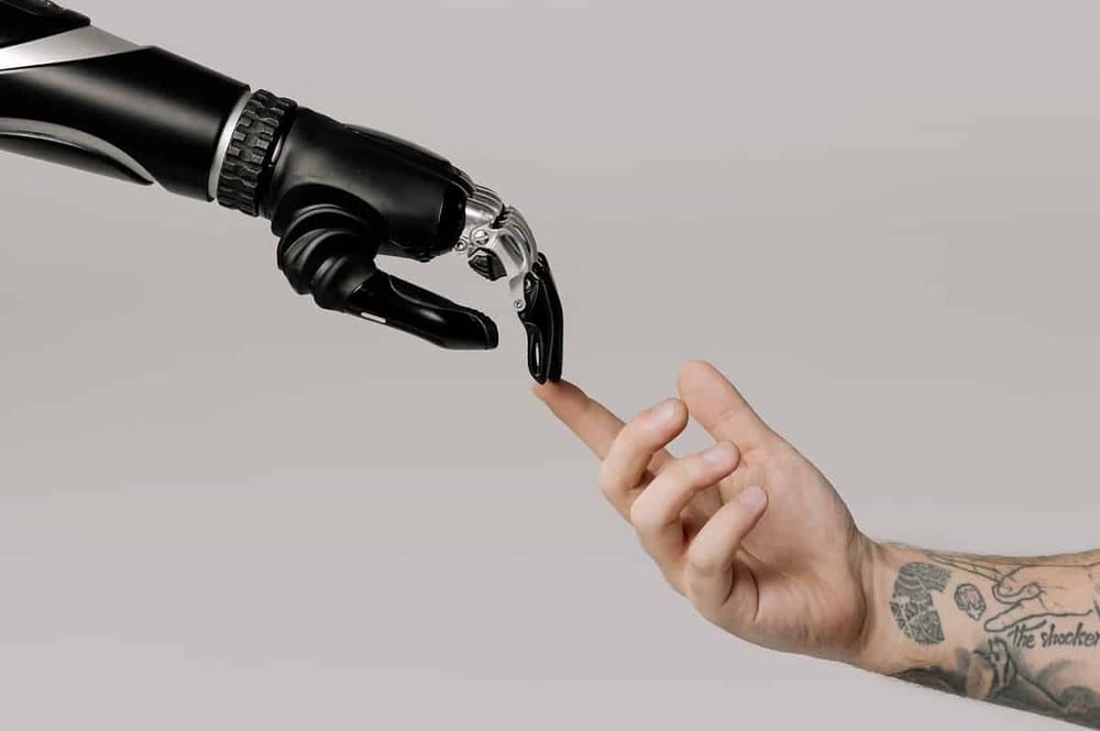 Free Bionic Hand And Human Hand Finger Pointing Stock Photo